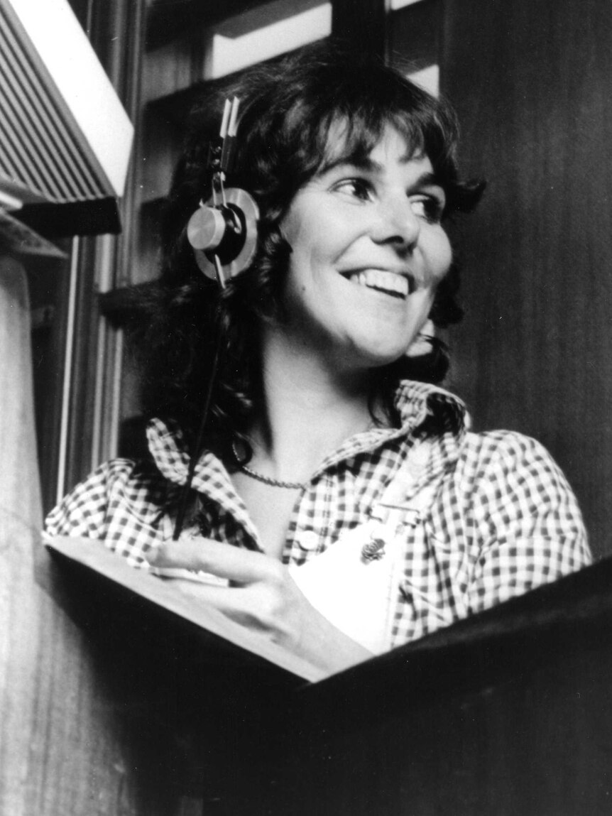 Black and white photo of Margaret Throsby in radio studio with headphones on.