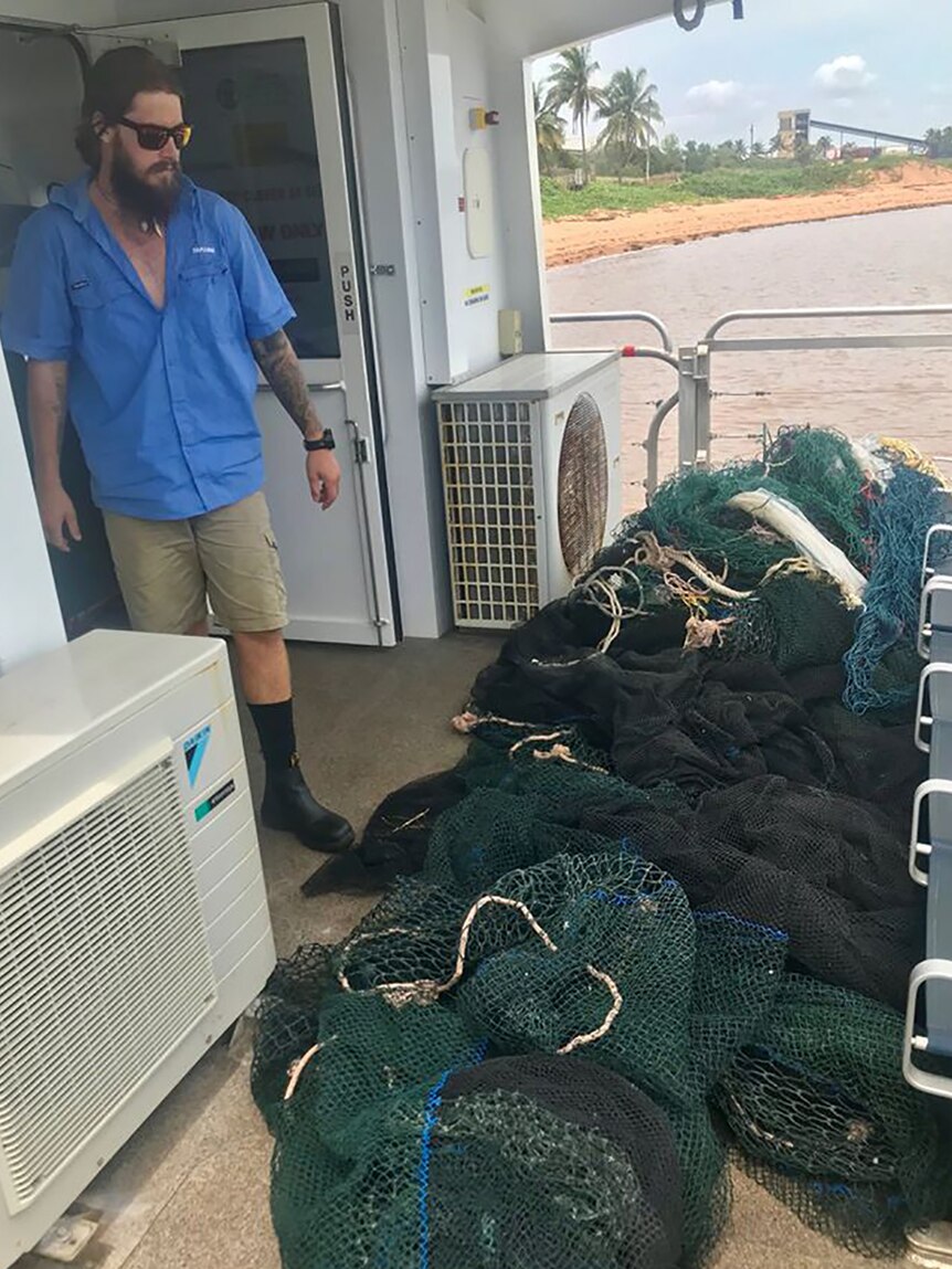 A photo of a large ghost net that's been hauled onto a ferry.