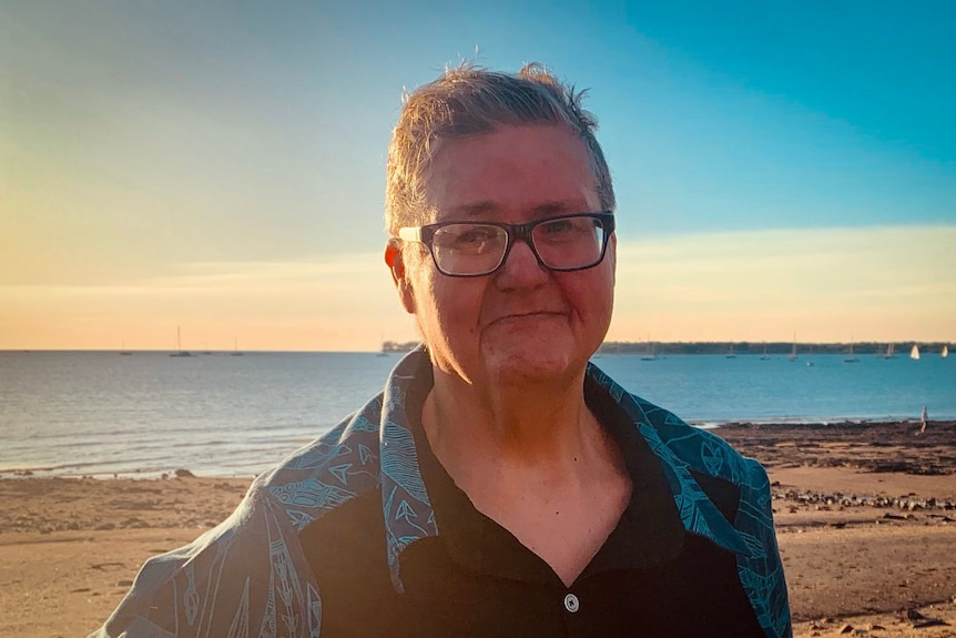 A portrait of a man at the beach.