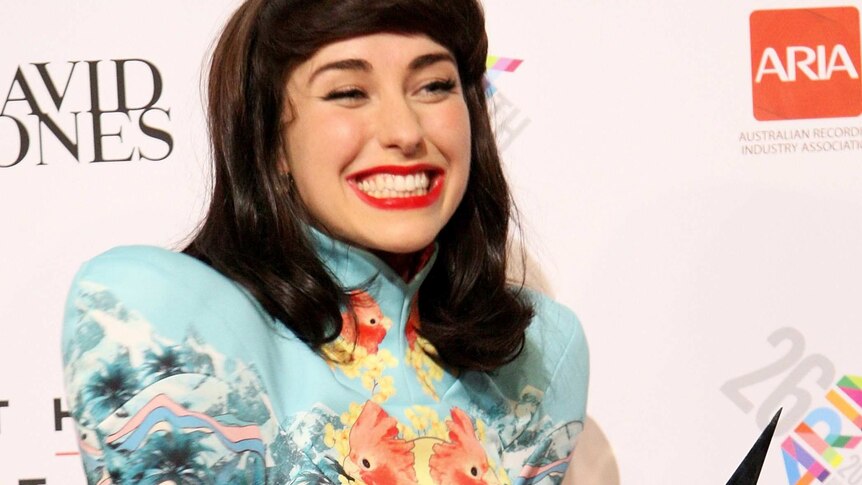 New Zealand-born Kimbra poses for photos with her best female artist award at the 2012 ARIAs.