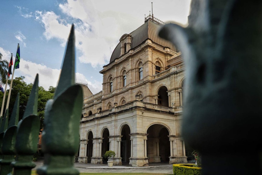 Queensland Parliament House in Brisbane through its front fence on George Street.