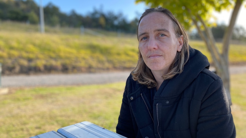 Stacey Lodge sits outside at a park bench.