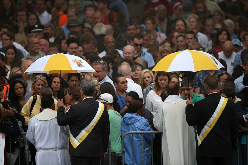 Spectators receive communion during the papal mass at the World Meeting of Families