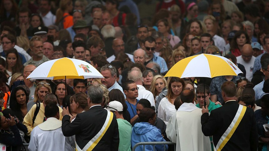 Spectators receive communion during the papal mass at the World Meeting of Families
