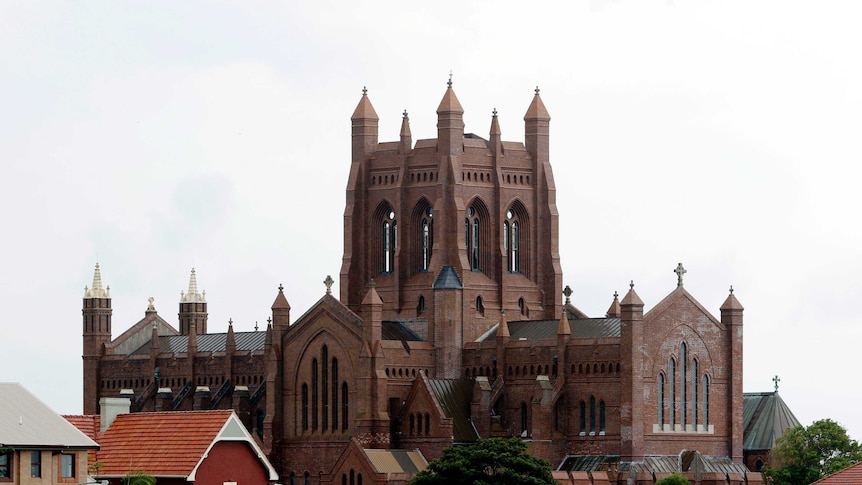 An imposing red brick Cathedral towers above the Newcastle skyline.