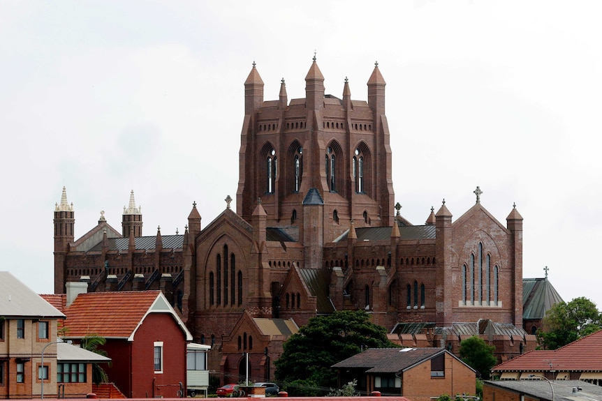 An imposing red brick Cathedral towers above the Newcastle skyline.