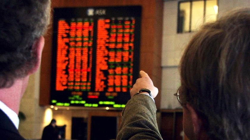 Investors watch share prices at the Australian Securities Exchange