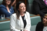Emma Husar closes her eyes in Parliament as she speaks about her experience with domestic violence