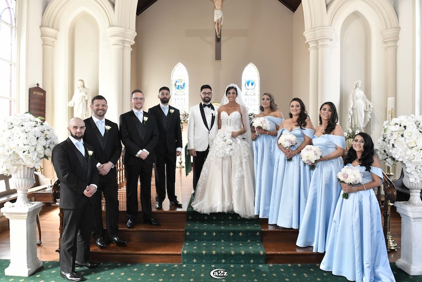 Venitta and Craig in church with their bridal party.