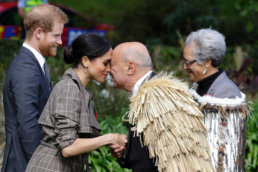 Meghan rubs noses with a man in an official Maori welcome ceremony