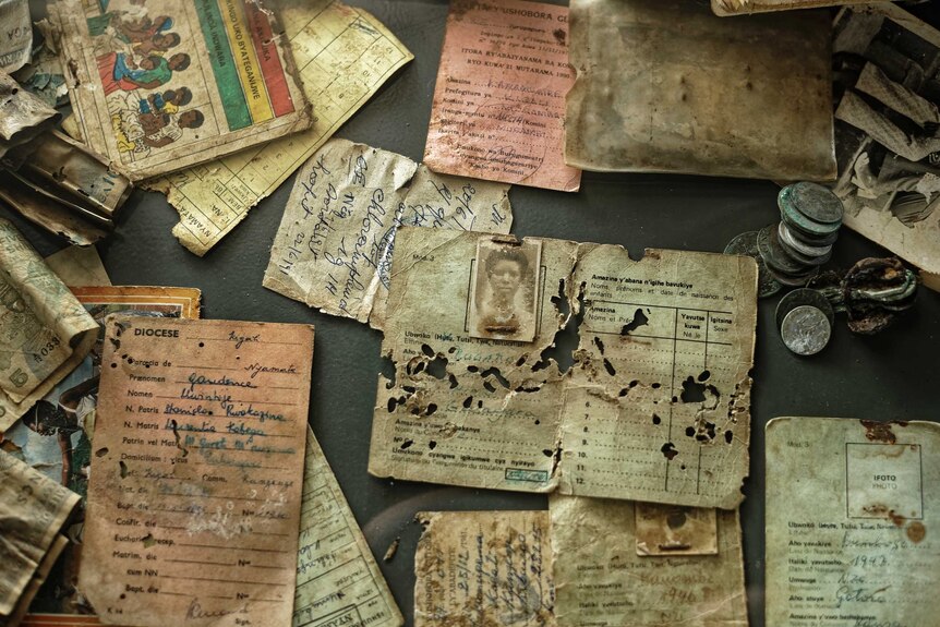 A collection of old tattered letters and documents collected from victims of genocide.