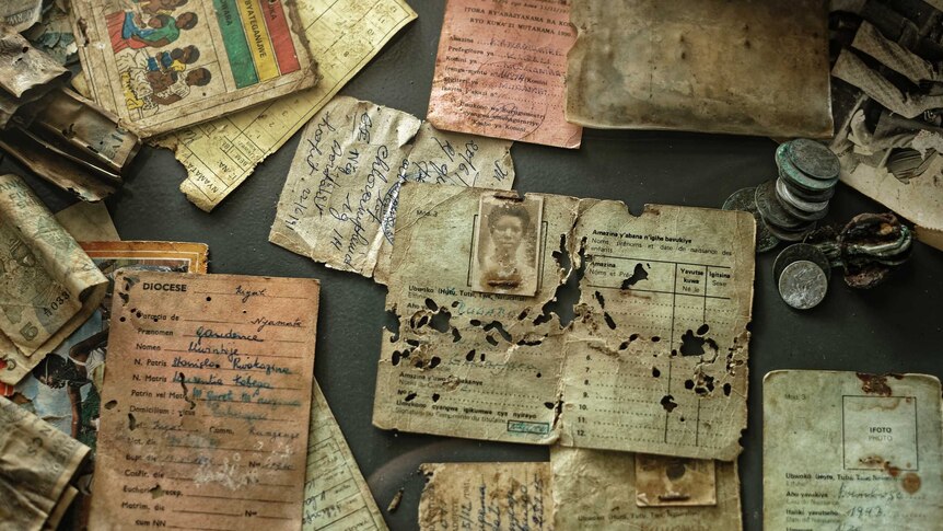 A collection of old tattered letters and documents collected from victims of genocide.