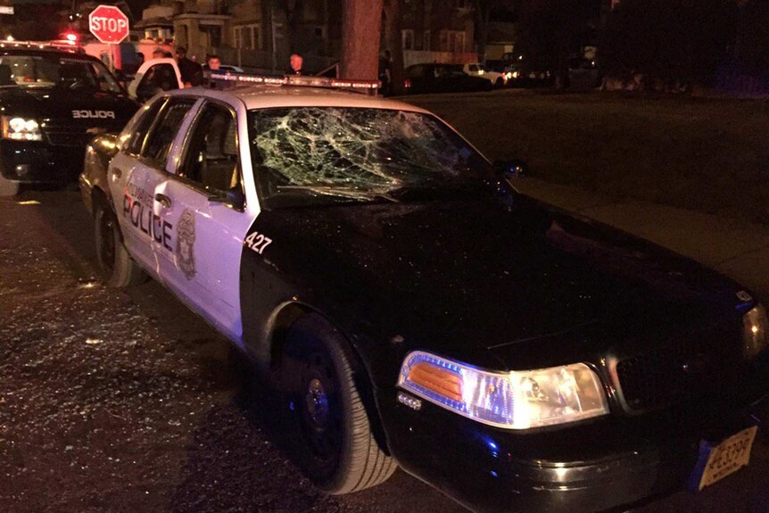 A police car with broken windows.