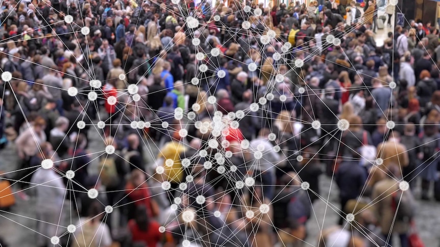 Visualization of coronavirus multiplying with a background of people at a train station.