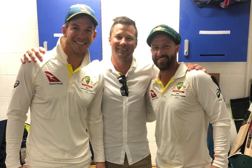 Three men in a sporting dressing room.