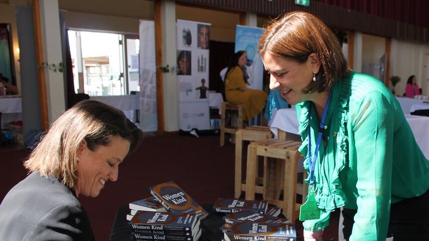 Kirstin Ferguson signs copy of Women Kind for Queensland Opposition leader Deb Frecklington