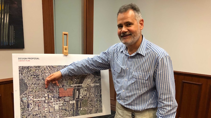 Council administrator Greg Chemello points to a map of the Ipswich CBD