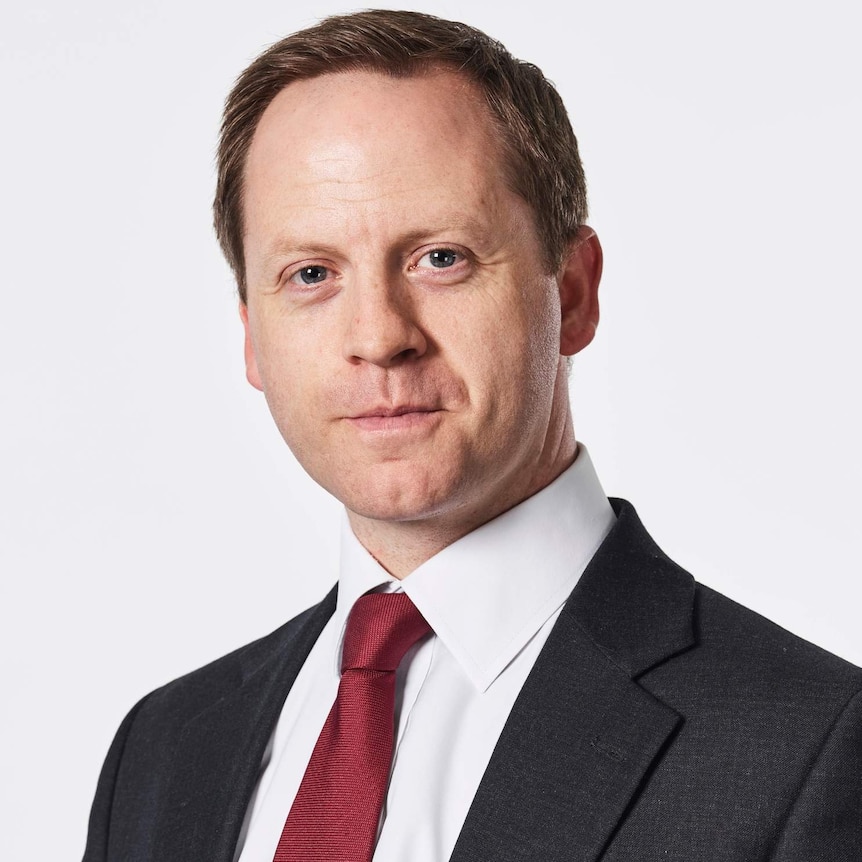 man in suit in front of a white background