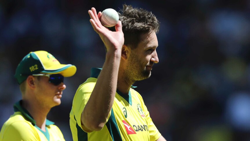 Andrew Tye holds up a ball to the Perth crowd after taking five wickets against England.