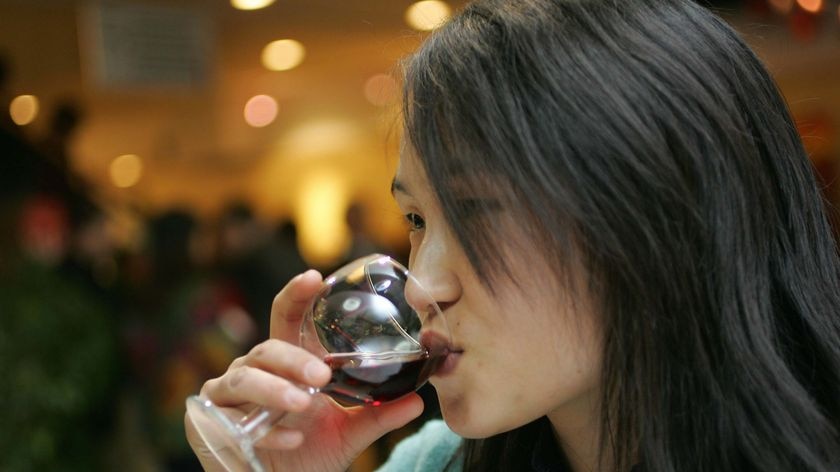 A woman sips wine