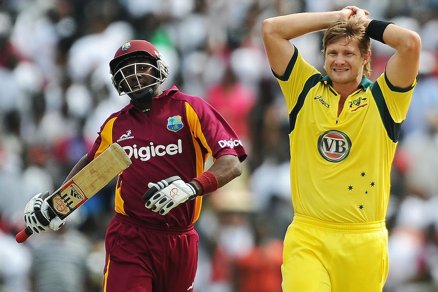 Shane Watson (R) reacts as West Indies batsman Dwayne Bravo takes a run during the third ODI in Kingstown on March 20, 2012.