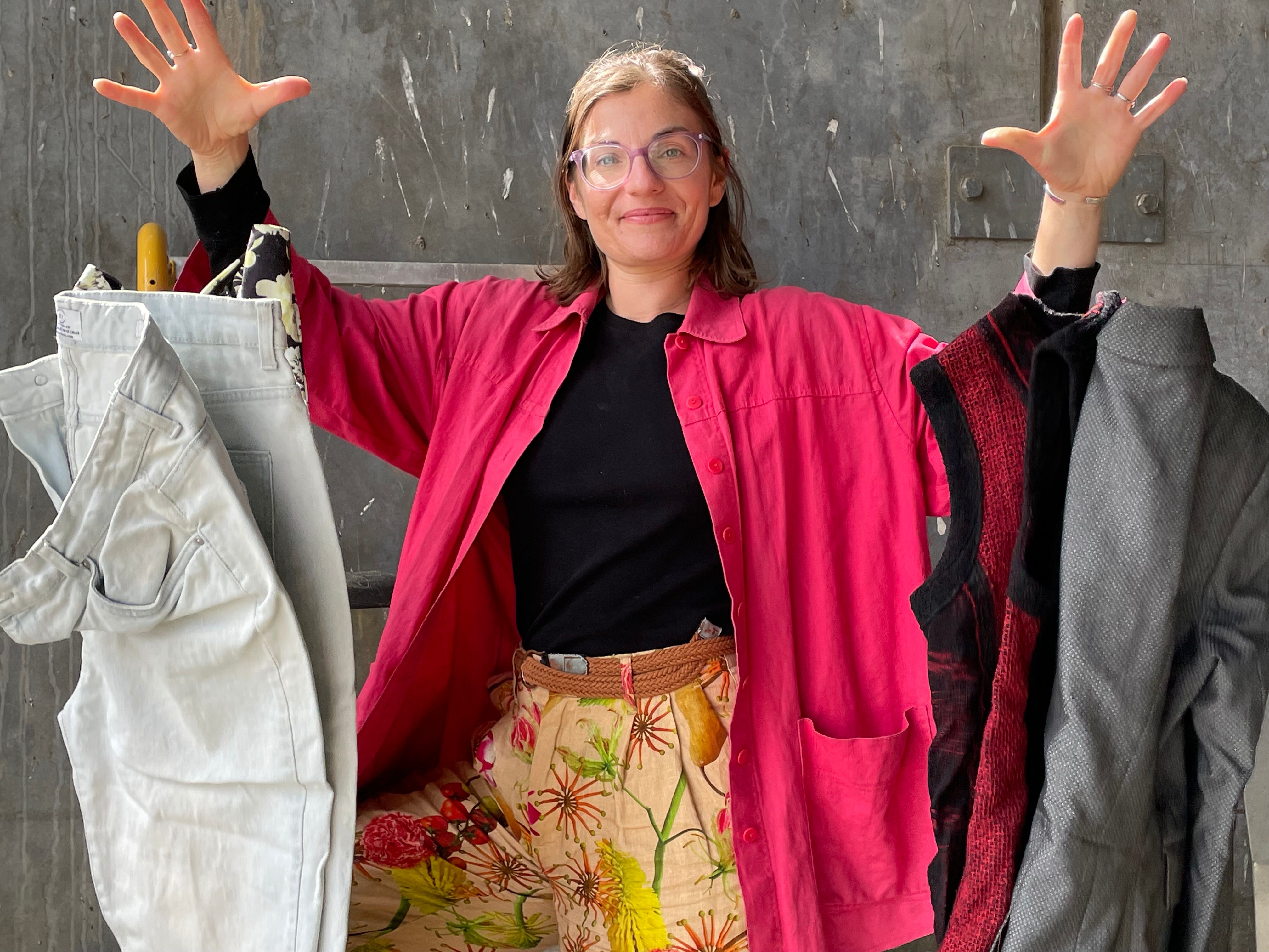 Woman with a handful of bright clothes.