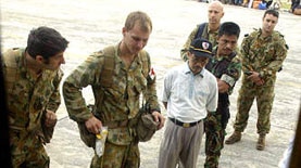 An Acehnese man receives aid from an Australian medic.
