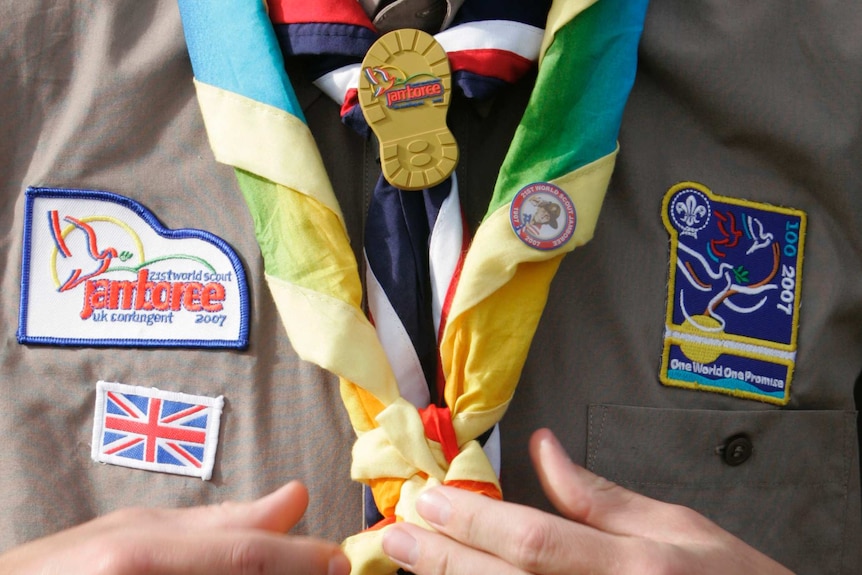 A scout adjusts his neckerchief at the 21st World Scout Jamboree at Highlands Park.