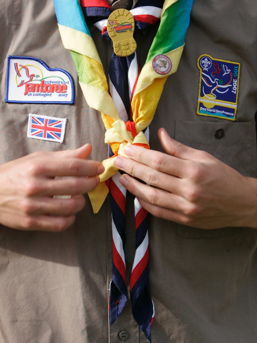A scout adjusts his neckerchief at the 21st World Scout Jamboree at Highlands Park.
