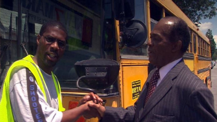 A construction worker (L) shakes the hand of Ward 8 local representative Marion Barry.