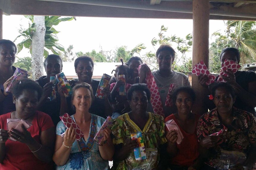 The 'Mammas' in a group photo holding their handmade reusable sanitary pads