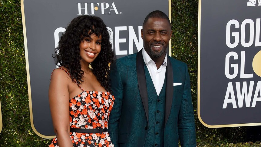 Idris Elba, right, and Sabrina Dhowre arrive on the red carpet