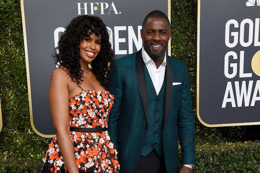 Idris Elba, right, and Sabrina Dhowre arrive on the red carpet