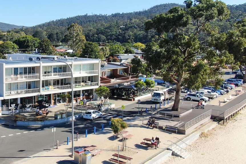 A building seen from above with trees and a road in the foreground