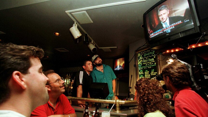 Bar patrons watch President Clinton deliver his speech to the nation late August 17, 1998.