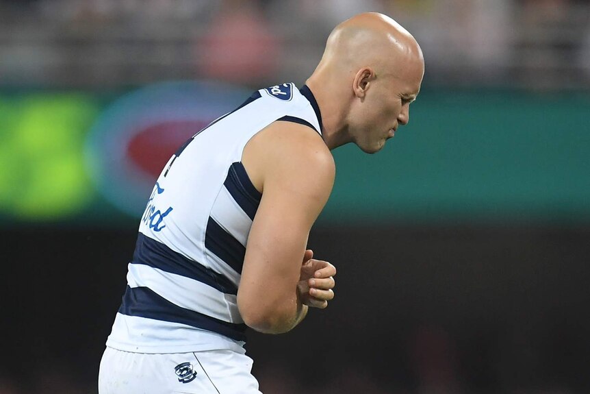 Gary Ablett hobbles off nursing his arm during the AFL grand final between Richmond and Geelong at the Gabba