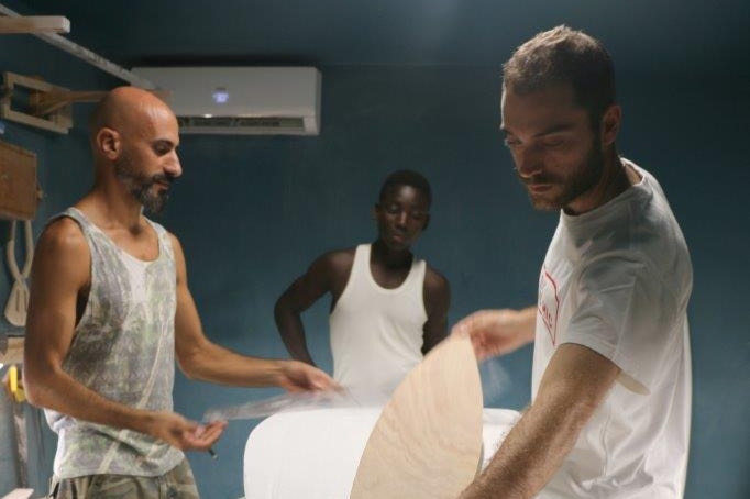 Hadi Beydoun, Paul Abbas and a local worker craft boards in their Abidjan factory.