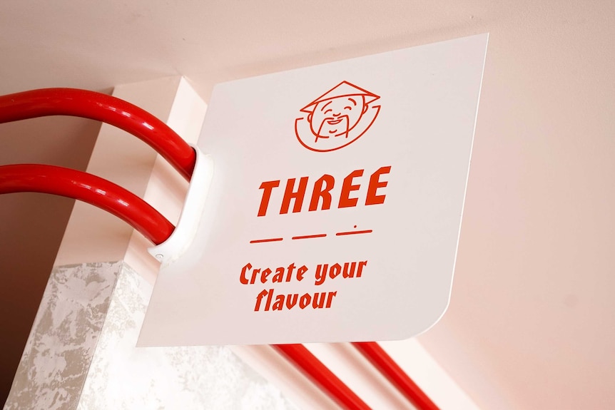 A red and white sign read 'Three: create your flavour'