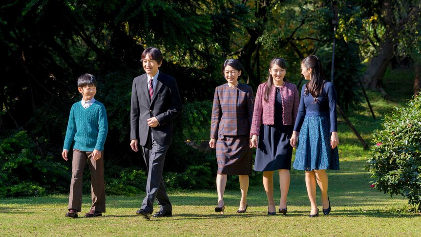Japan's Prince Akishino and his wife and three children are seen walking in a garden