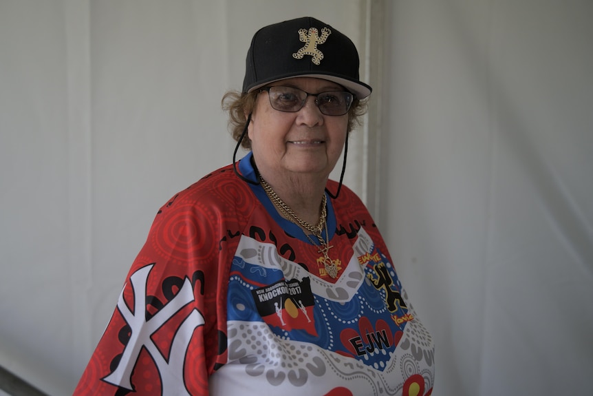 Gwen Wright smiles at the camera, wearing a Newcastle Yowies shirt