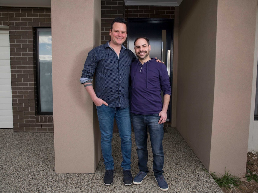 Dean and Adam at the front of their home