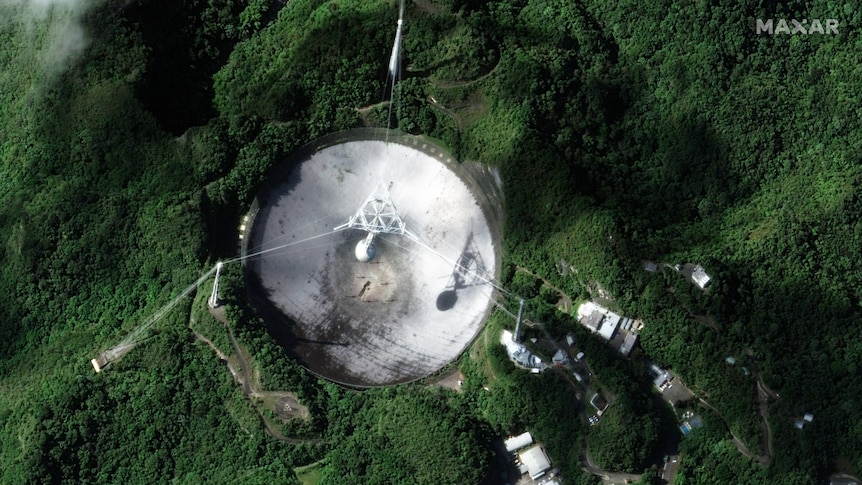 A satellite photo of the Arecibo Observatory's telescope