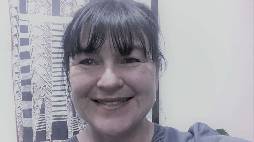 A head shot of a woman smiling and looking at the camera.