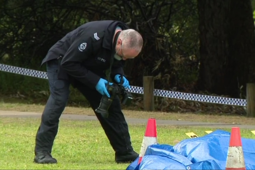 Police officer taking photos of the crash scene