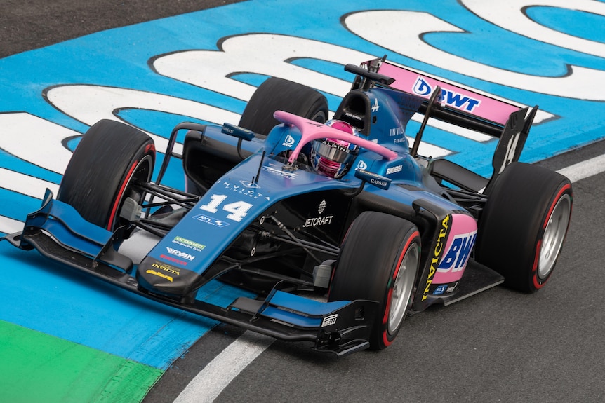 Australian Formula 2 driver Jack Doohan (14) in blue and pink racing car.