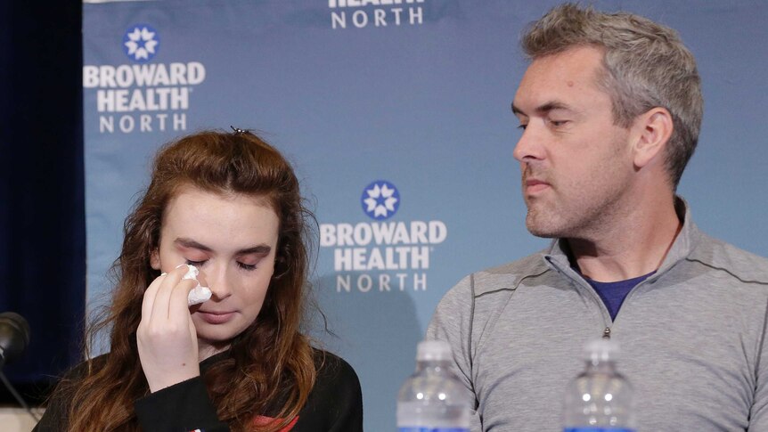 Maddy Wilford wipes a tear from her eye as her father watches on.