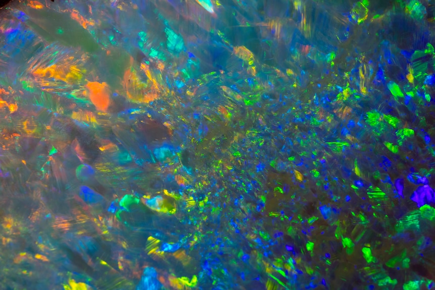 A close up of the yowah Moon Opal showing the many colours: red, blue, green range of colours