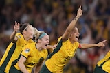 Australia players run to celebrate after winning a Women's WOrld Cup quarterfinal against France.
