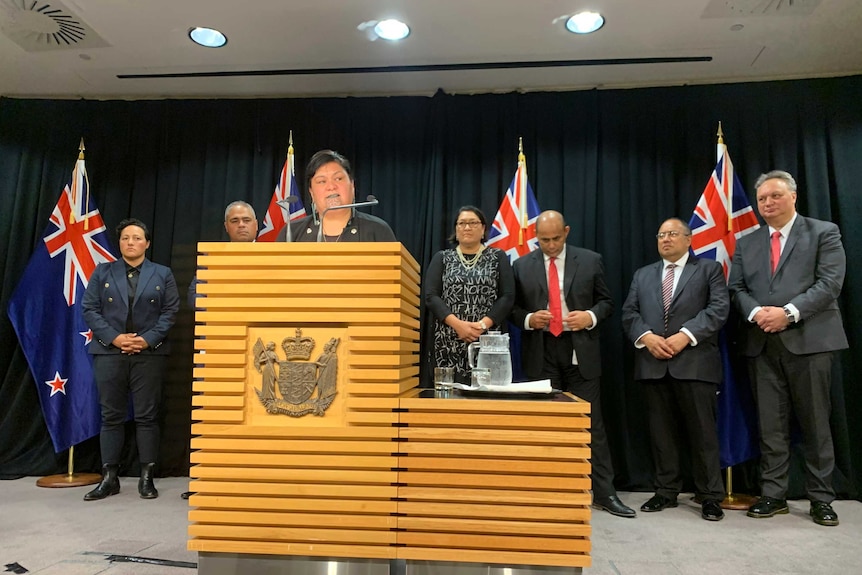 Nanaia Mahuta speaks at a lectern, with other MPs behind her.