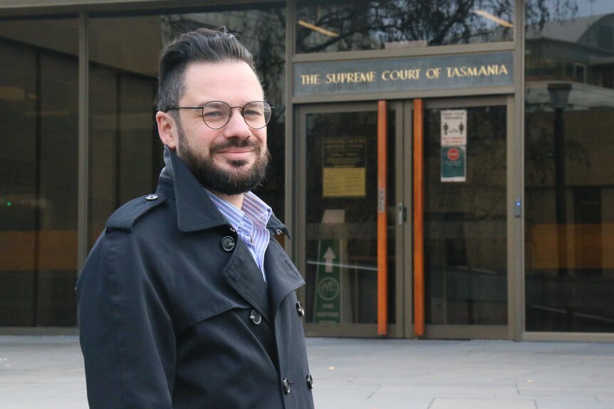 Sebastian Buscemi standing in front of the Supreme Court of Tasmania.